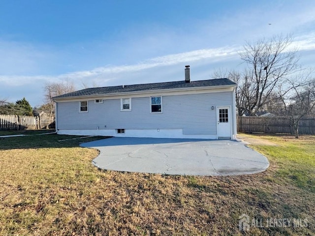 rear view of property featuring a yard and a patio