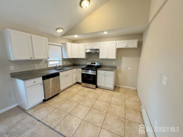 kitchen with baseboard heating, white cabinetry, stainless steel appliances, sink, and vaulted ceiling