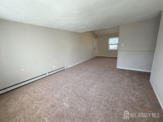 carpeted spare room featuring a baseboard radiator and a textured ceiling