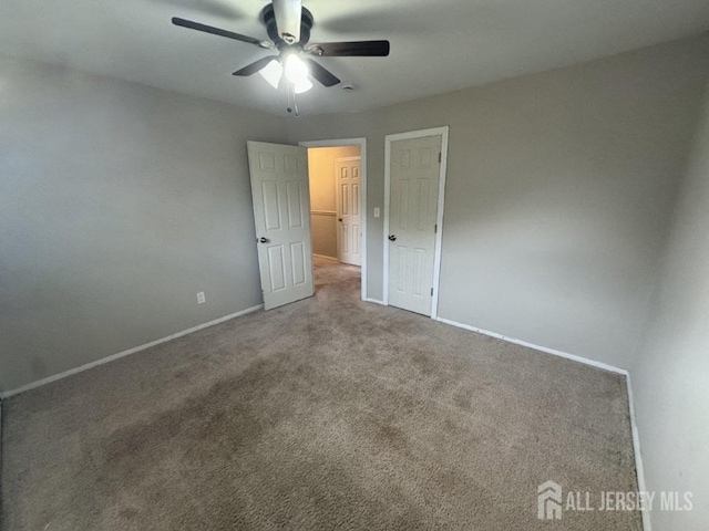 unfurnished bedroom with carpet floors and ceiling fan