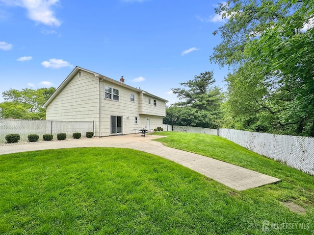 12 Dana Estates Dr, Old Bridge, NJ 08859 - rear view of house featuring a chimney and a patio