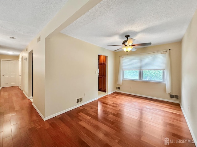 12 Dana Estates Dr, Old Bridge, NJ 08859 - unfurnished room featuring a textured ceiling, light wood-style floors, ceiling fan, and baseboards
