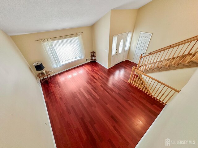 12 Dana Estates Dr, Old Bridge, NJ 08859 - entrance foyer with wood finished floors, baseboards, stairs, and vaulted ceiling