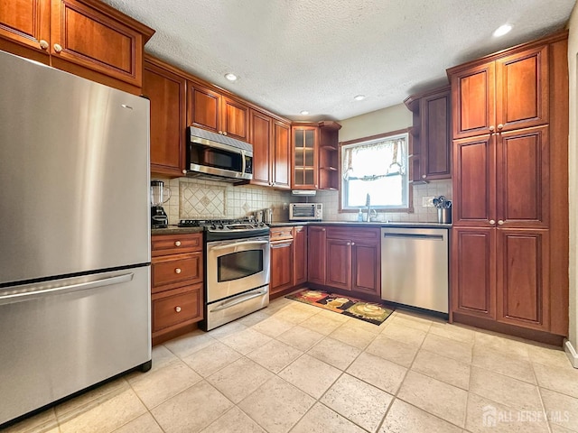 12 Dana Estates Dr, Old Bridge, NJ 08859 - kitchen with stainless steel appliances, dark countertops, recessed lighting, backsplash, and a textured ceiling