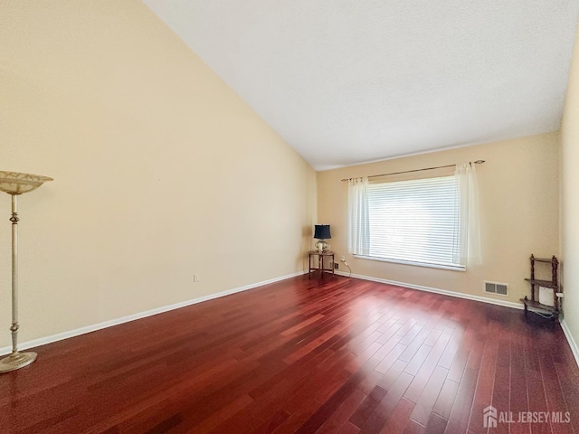 12 Dana Estates Dr, Old Bridge, NJ 08859 - unfurnished living room featuring lofted ceiling, dark wood-style flooring, and baseboards