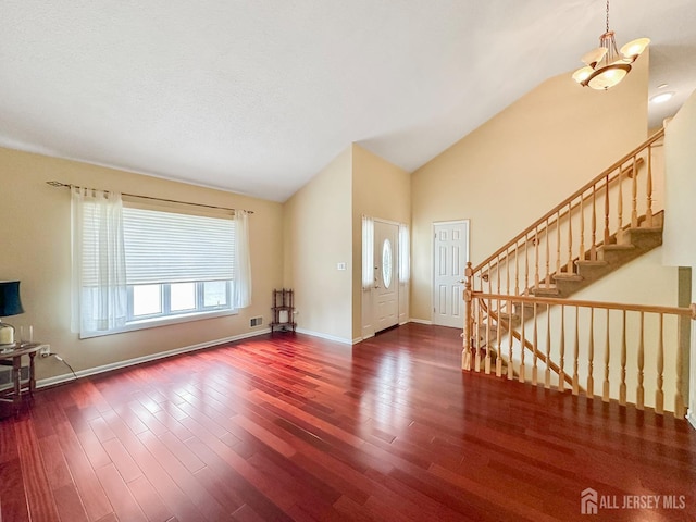 12 Dana Estates Dr, Old Bridge, NJ 08859 - unfurnished living room with dark wood-type flooring, stairs, baseboards, and high vaulted ceiling