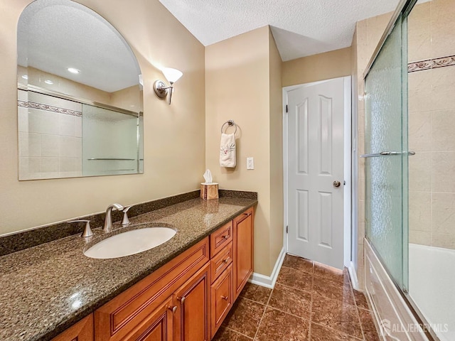 12 Dana Estates Dr, Old Bridge, NJ 08859 - bathroom with vanity, a textured ceiling, combined bath / shower with glass door, baseboards, and tile patterned floors