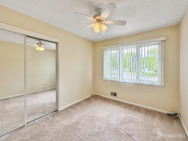 12 Dana Estates Dr, Old Bridge, NJ 08859 - unfurnished bedroom featuring carpet floors, a closet, baseboards, and a textured ceiling