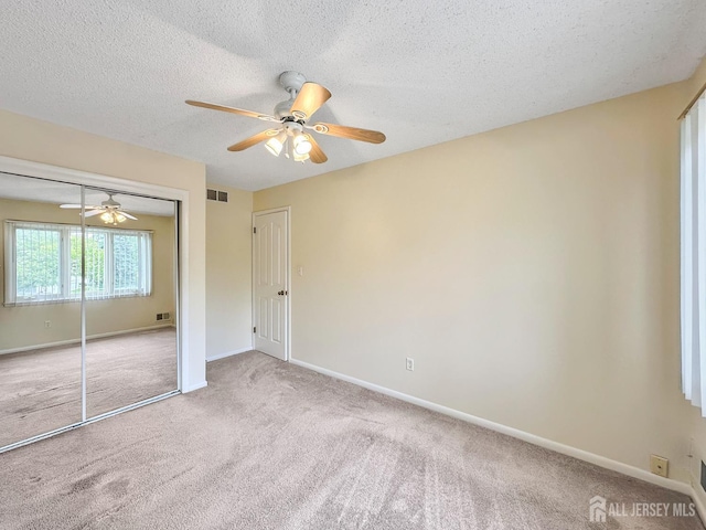 12 Dana Estates Dr, Old Bridge, NJ 08859 - unfurnished bedroom featuring carpet flooring, a textured ceiling, baseboards, a closet, and ceiling fan