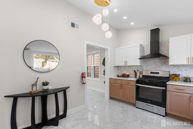 251 Church St, South Amboy, NJ 08879 - kitchen featuring stainless steel gas range, wall chimney exhaust hood, light marble finish floors, decorative backsplash, and recessed lighting