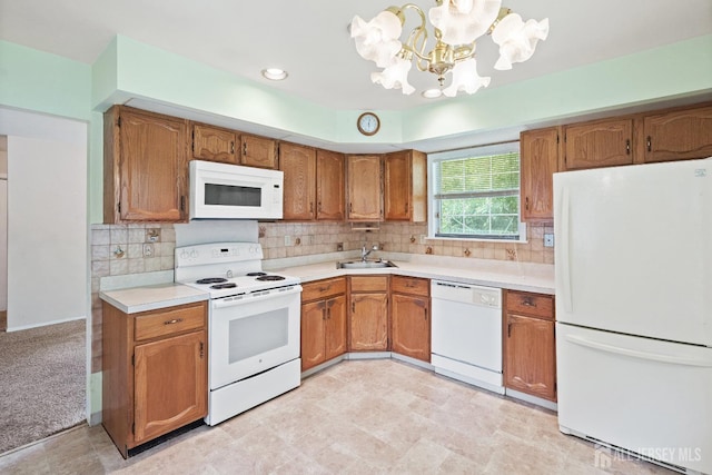 153 Concordia Cir Unit D, Monroe, NJ 08831 - kitchen with white appliances, a chandelier, light countertops, brown cabinetry, and decorative backsplash