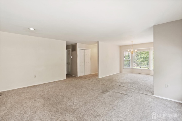 153 Concordia Cir Unit D, Monroe, NJ 08831 - spare room featuring a chandelier and carpet
