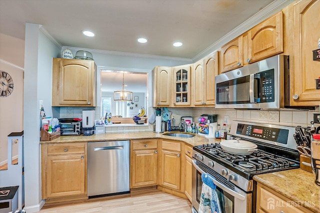 325 Mcdowell Dr, East Brunswick, NJ 08816 - kitchen with appliances with stainless steel finishes, ornamental molding, backsplash, light wood-style floors, and glass insert cabinets