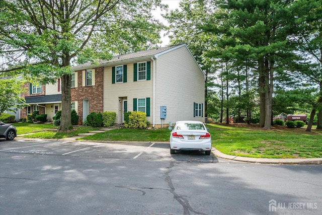 325 Mcdowell Dr, East Brunswick, NJ 08816 - view of front of home with uncovered parking and a front lawn