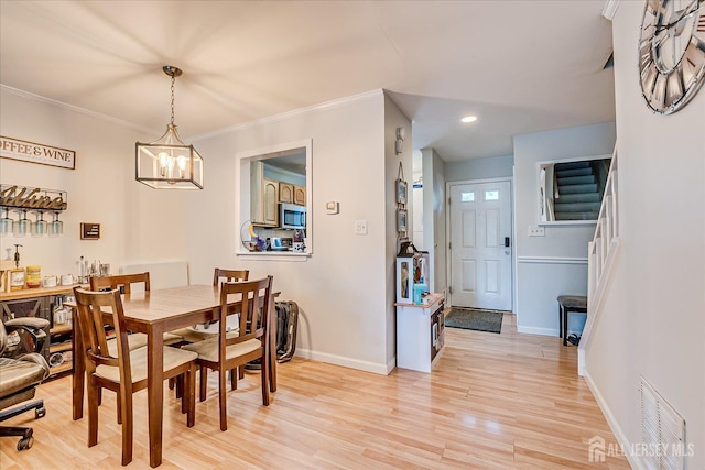 325 Mcdowell Dr, East Brunswick, NJ 08816 - dining room featuring a chandelier, light wood finished floors, stairway, recessed lighting, and crown molding