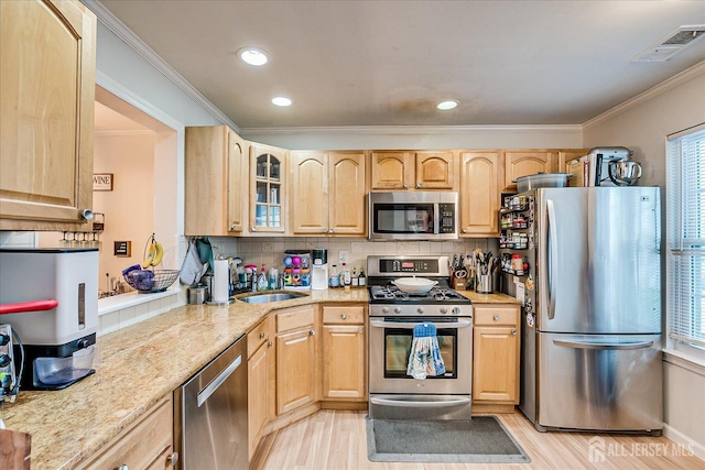 325 Mcdowell Dr, East Brunswick, NJ 08816 - kitchen with stainless steel appliances, light brown cabinets, crown molding, light wood-style floors, and decorative backsplash