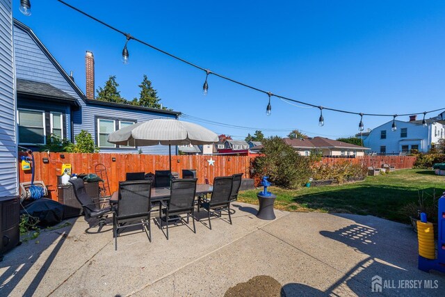 view of patio featuring a fenced backyard, a residential view, and outdoor dining space