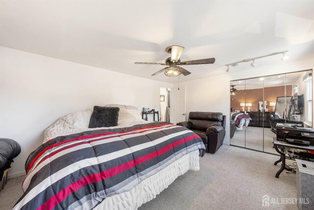 bedroom featuring a ceiling fan and light colored carpet