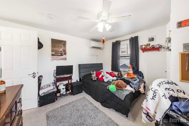 bedroom featuring a ceiling fan and a wall unit AC