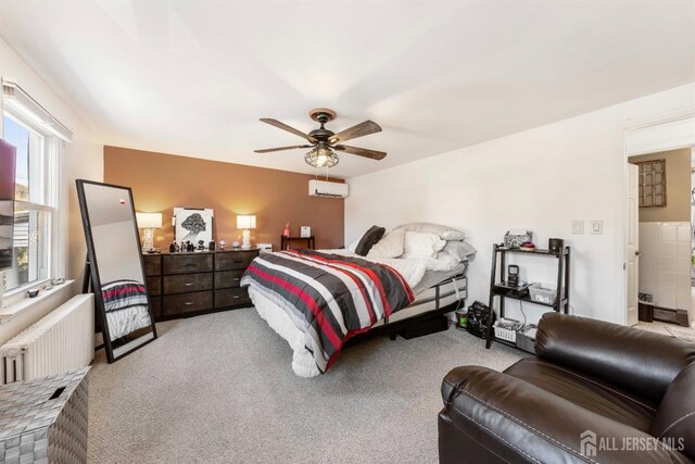 bedroom with a ceiling fan, radiator, light colored carpet, and a wall mounted air conditioner