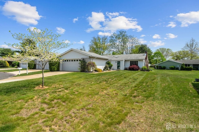 ranch-style home featuring a garage, concrete driveway, and a front lawn