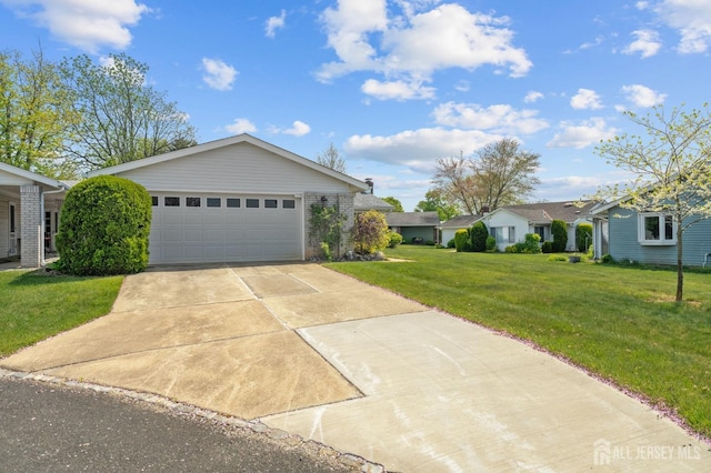 ranch-style home featuring concrete driveway, a front lawn, brick siding, and a garage