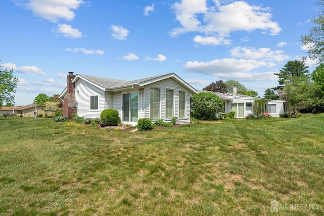 339 Quinton Dr Unit 339C, Monroe, NJ 08831 - view of front facade with a chimney and a front lawn