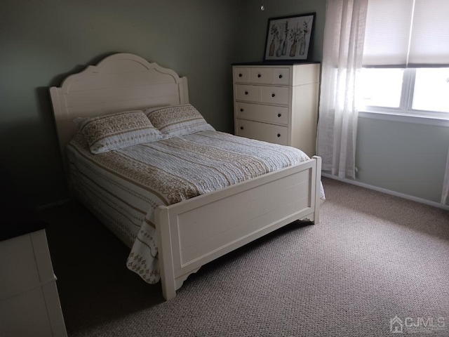 bedroom with carpet floors and baseboards