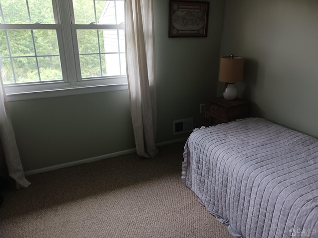 bedroom featuring carpet floors, baseboards, and visible vents