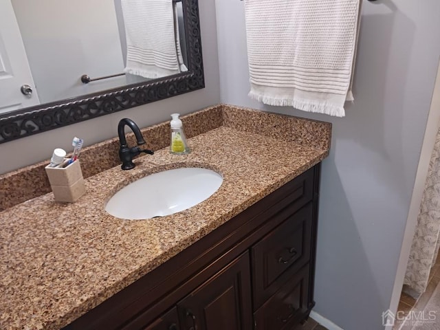 bathroom featuring baseboards and vanity