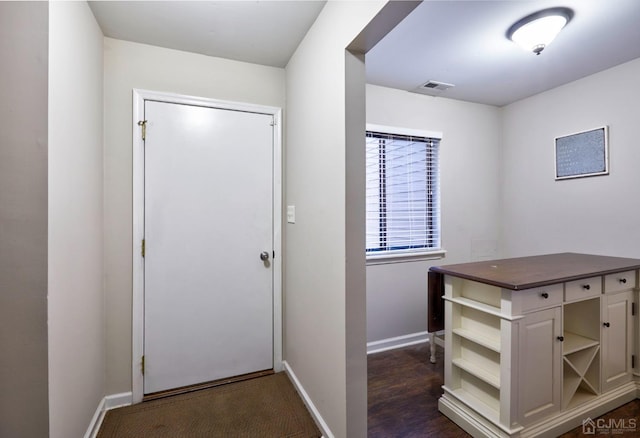 doorway with dark hardwood / wood-style flooring