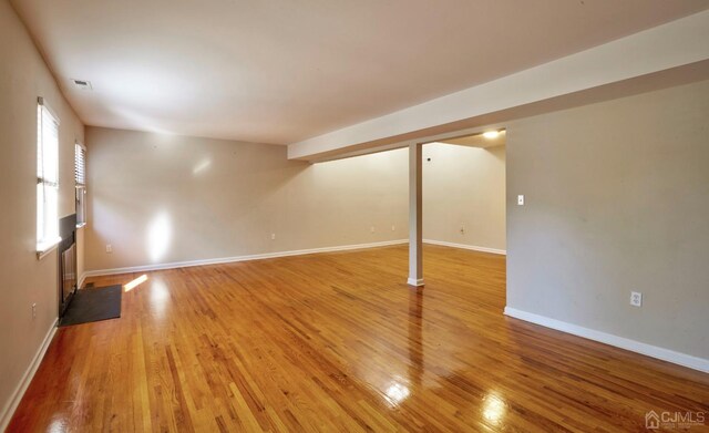 empty room with hardwood / wood-style flooring