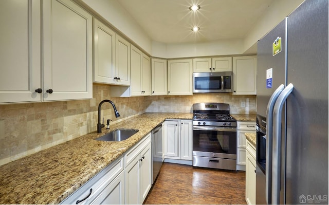 kitchen featuring dark hardwood / wood-style floors, stainless steel appliances, tasteful backsplash, and sink