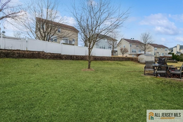 view of yard with a residential view and fence