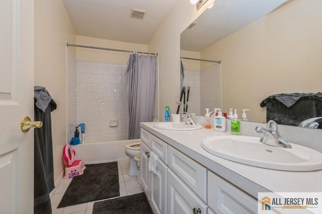 bathroom with double vanity, tile patterned flooring, visible vents, and a sink