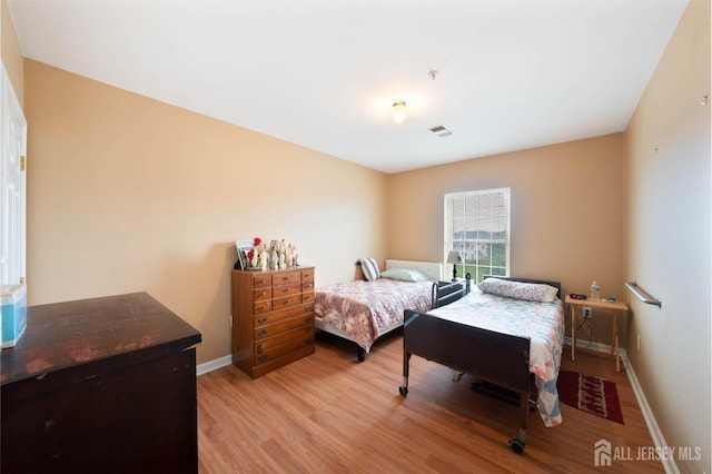 bedroom with light hardwood / wood-style flooring