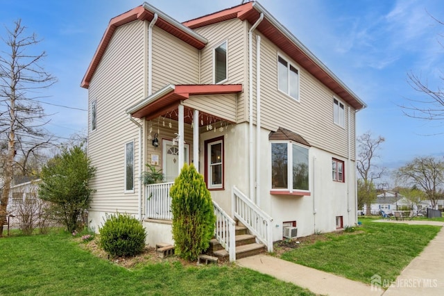 40 Riverview Ave, Piscataway, NJ 08854 - view of front facade with a front lawn, covered porch, and stucco siding