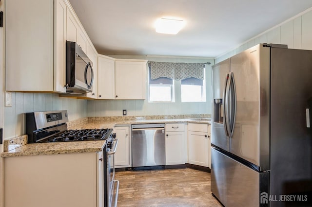 40 Riverview Ave, Piscataway, NJ 08854 - kitchen with appliances with stainless steel finishes, light wood-style floors, white cabinets, and light stone countertops