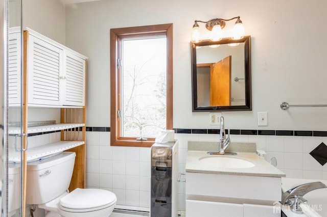 40 Riverview Ave, Piscataway, NJ 08854 - bathroom with tile walls, toilet, vanity, plenty of natural light, and a wainscoted wall