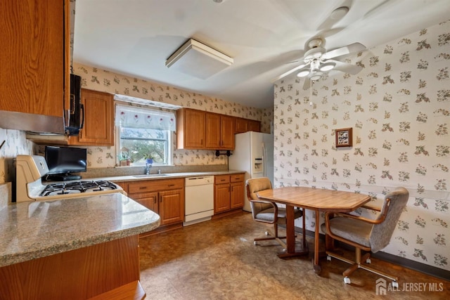 kitchen featuring wallpapered walls, white appliances, ceiling fan, a sink, and tile patterned floors