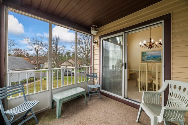 sunroom featuring a chandelier