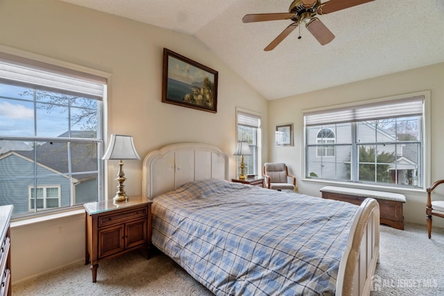 bedroom with baseboards, ceiling fan, light colored carpet, and vaulted ceiling