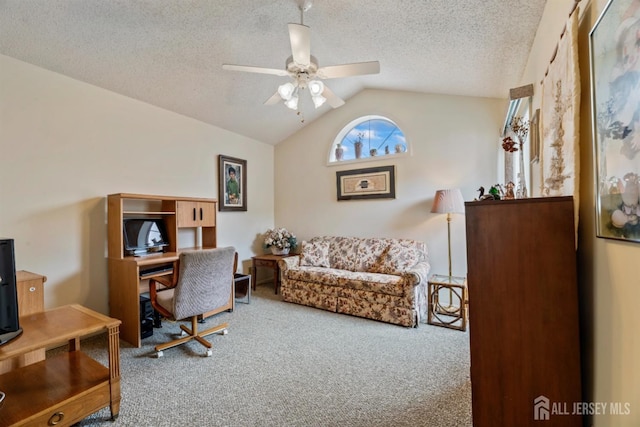 carpeted office space with lofted ceiling, ceiling fan, and a textured ceiling