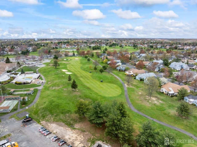 birds eye view of property with golf course view and a residential view