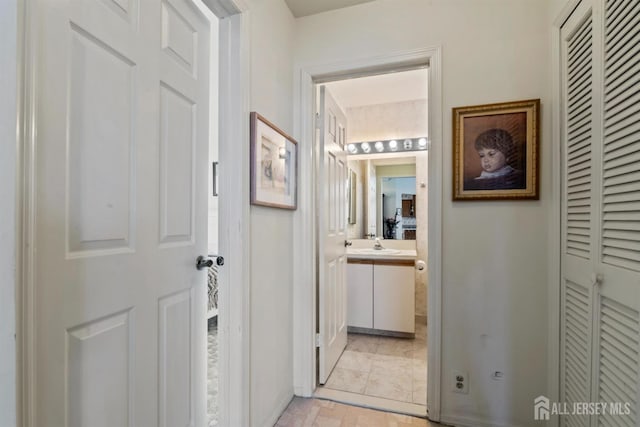 hallway featuring a sink
