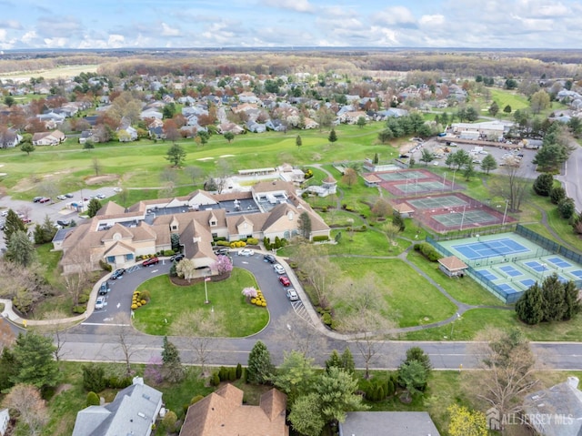 drone / aerial view with view of golf course and a residential view