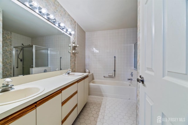 bathroom with a shower stall, tile patterned floors, double vanity, and a sink