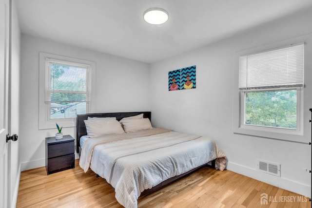 374 Nottingham Way, Union Twp, NJ 07083 - bedroom with multiple windows, baseboards, and light wood-type flooring