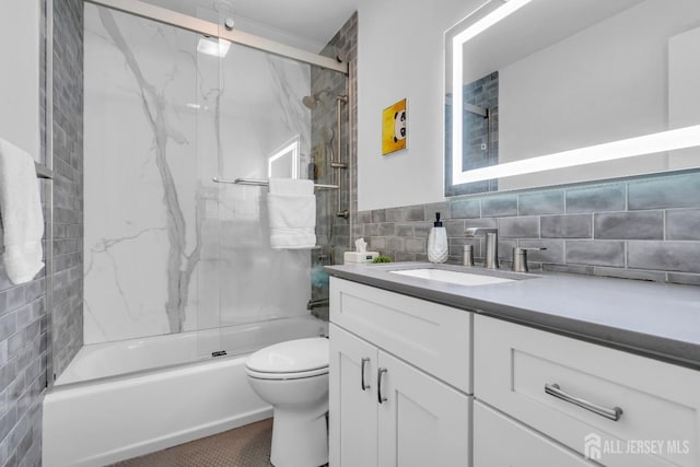 374 Nottingham Way, Union Twp, NJ 07083 - bathroom featuring tile walls, vanity, toilet, and shower / bath combination with glass door