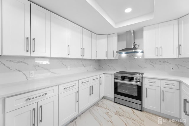 kitchen with white cabinets, electric range, and wall chimney exhaust hood